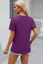 Purple ribbed tee with lace raglan sleeves and crew neck.