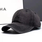 Black denim baseball hat with embroidered detail and curved brim