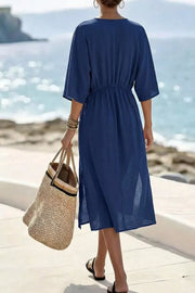 Blue midi dress with V-neck, elastic waist, and side slits.