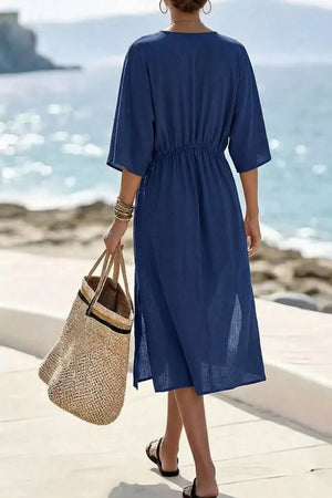 Blue midi dress with V-neck, elastic waist, and side slits.