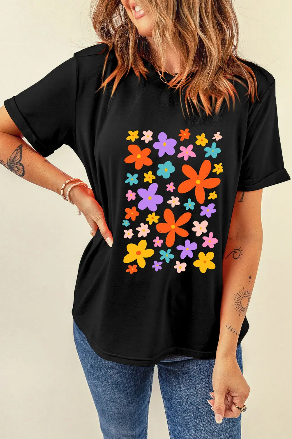 Black round neck tee with colorful bloom print and cuffed short sleeves.
