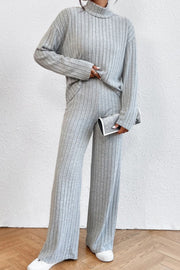 Light gray ribbed knit turtleneck loungewear set with wide leg pants.