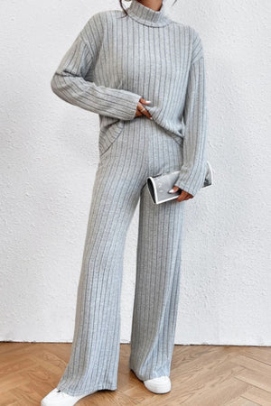 Light gray ribbed knit turtleneck loungewear set with wide leg pants.