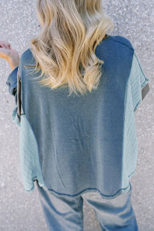 Panelled waffle knit blouson top in dusty blue with contrasting panels and a relaxed fit.