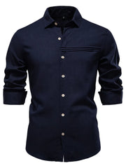 Navy linen button-up shirt with pleated pocket detail and cuffed sleeves.