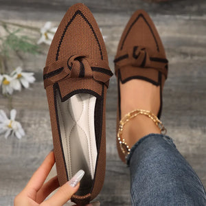 Brown mesh pointe slip-on flats with black trim and bow detail.