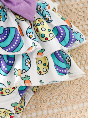 Easter graphic bodysuit and skirt set with carrot and egg print, purple bow detail.