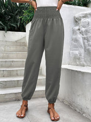 Gray smocked waistline relaxed-fit trousers with a single cargo pocket.