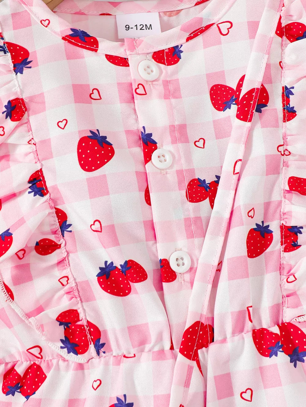 Strawberry print baby jumpsuit with ruffle trim and button front.