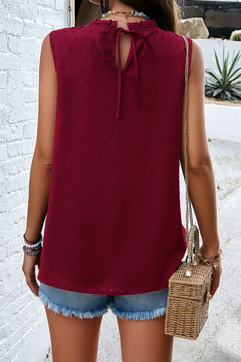 Wine textured yoke dot tank top with ruffled neckline and tie back detail.