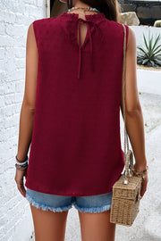 Wine textured yoke dot tank top with ruffled neckline and tie back detail.