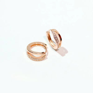 Delicate rose gold hoop earrings with pave crystal accents.