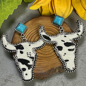 Cowhide bull head earrings with turquoise studs and silver trim.