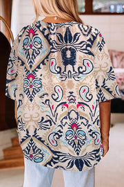 Paisley print blouse in ivory with slit sleeves and a V-neckline.