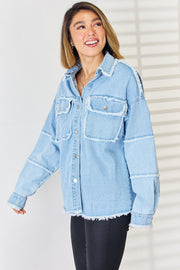 Light wash denim overshirt with patchwork details and frayed edges.