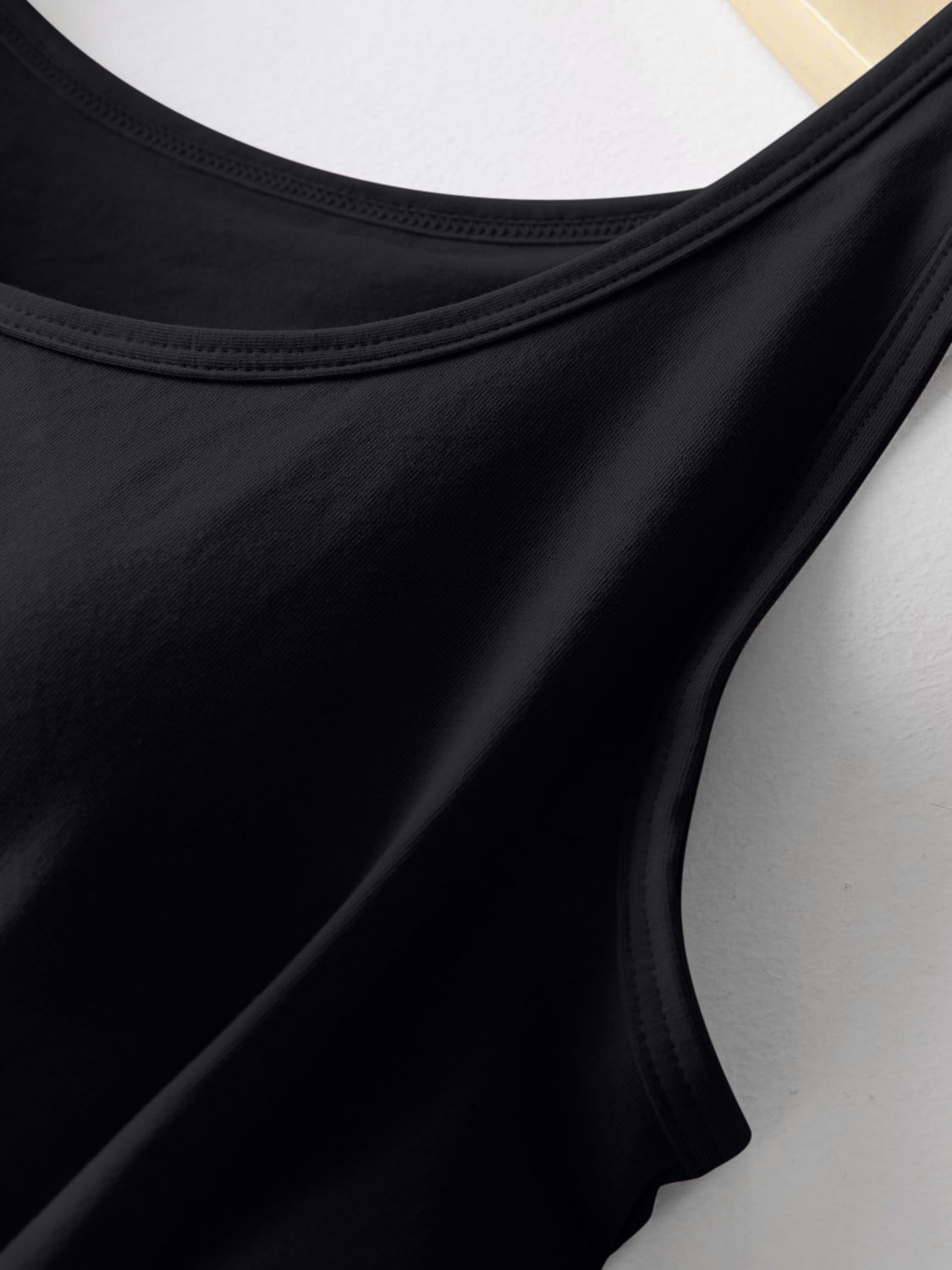 Black built-in support tank top with scoop neckline and ribbed texture.