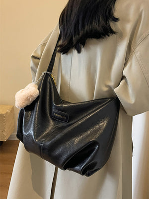 Black pu leather crossbody bag with chain detail and fluffy charm