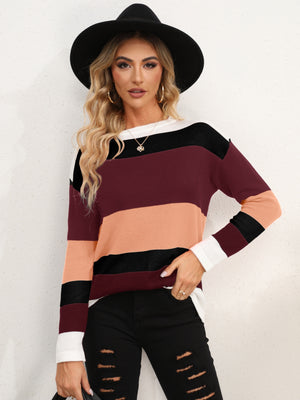 Colorblock crewneck sweater in acrylic with horizontal stripes of burgundy, peach, and black.