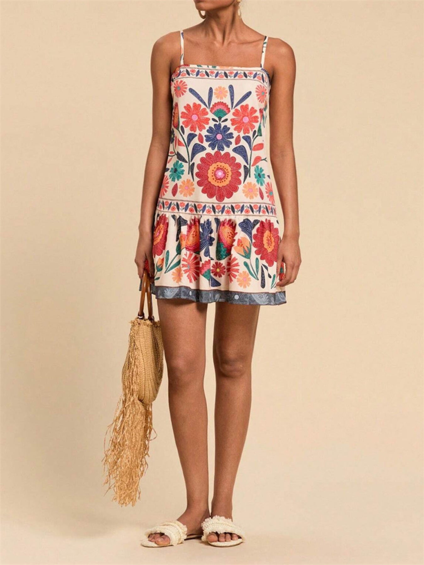 Playful printed mini dress with spaghetti straps, square neck, and tiered hem. Multicolor floral pattern.