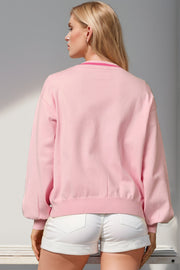 Blush pink acrylic cardigan with ribbed cuffs and neckline detail.