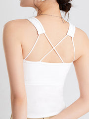 White crop tank top with criss-cross spaghetti straps on the back.