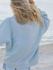 Sky blue crew neck sweatshirt with relaxed fit, part of a lounge set.