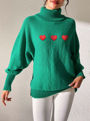 Green turtleneck sweater with balloon sleeves and red heart appliqué detail