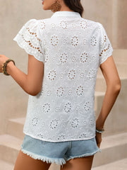 White eyelet embroidered button-up maternity overshirt with short sleeves and a collared neckline.