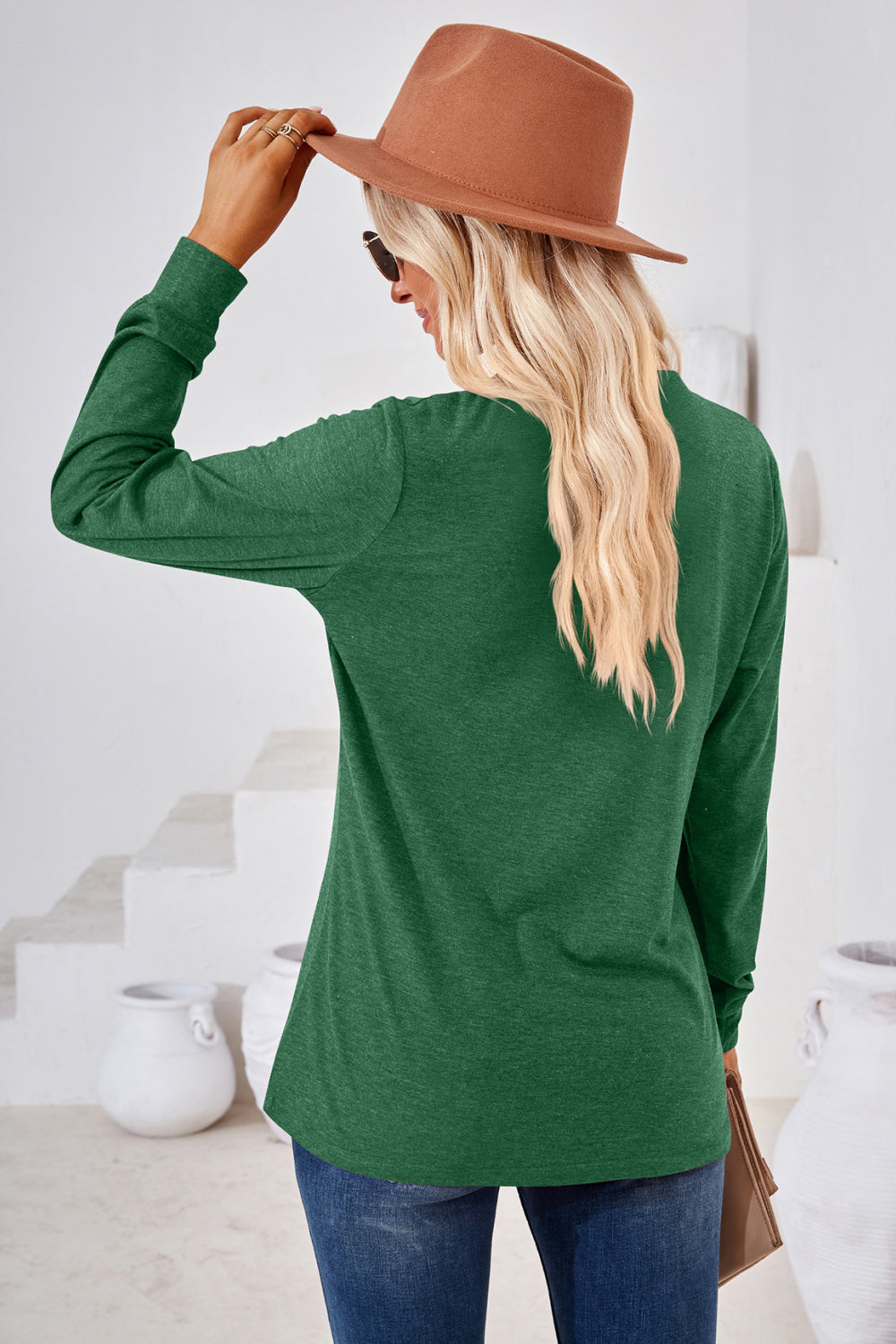 Dark green Henley neckline jersey top with long sleeves.