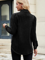 Black denim blouse with ruffled puff sleeves and button cuffs