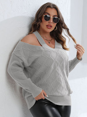 Light gray diamond knit sweater with asymmetric cold shoulder and V-neck.
