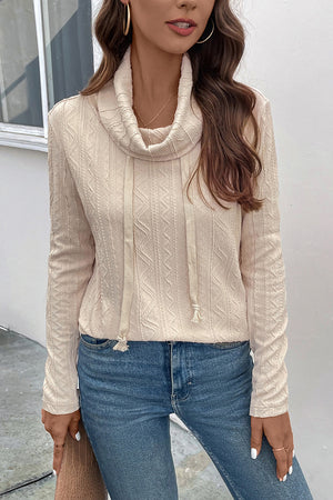 Beige textured cowl neck drawstring knit sweater with cable detail.
