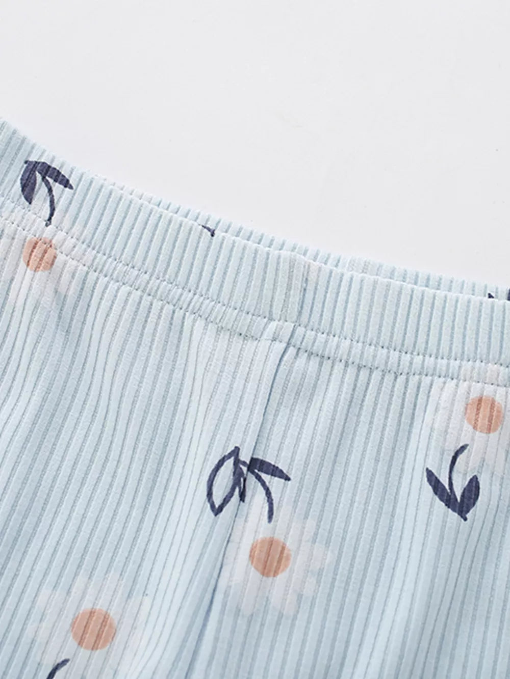 Baby girls' light blue striped pants with a floral print.