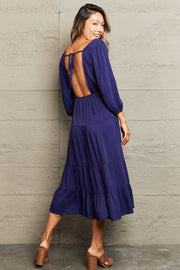 Navy backless empire waist tiered midi dress with balloon sleeves and tie back.