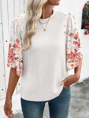 White ribbed half sleeve top with floral print sleeves and crew neck.