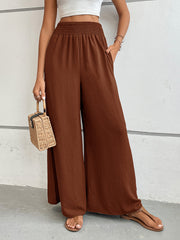 Textured palazzo lounge trousers in dark brown with a smocked waistband and wide legs.