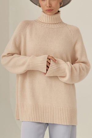 Blush pink cashmere turtleneck sweater with raglan sleeves and ribbed cuffs and hem.