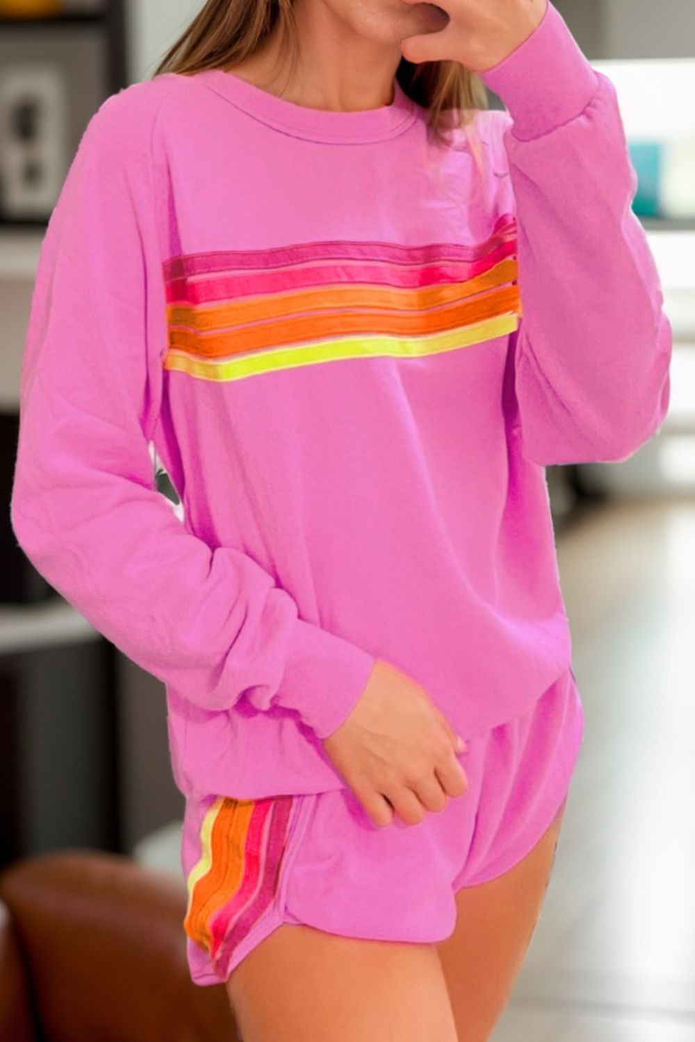 Fuchsia pink loungewear set with retro stripe detail on sweatshirt and shorts.
