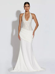 White sequin halter neck maxi gown with draped skirt and train.