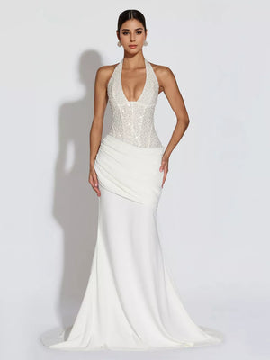 White sequin halter neck maxi gown with draped skirt and train.