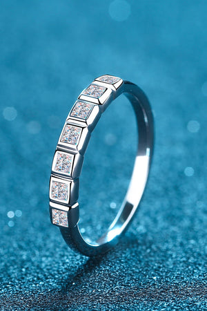 Silver band ring with princess cut diamonds in square settings