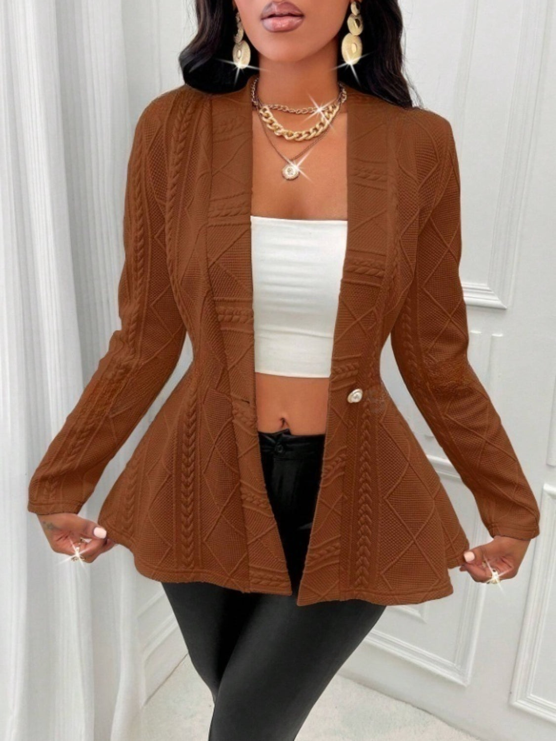 Textured knit peplum blazer in tan with a single button and cable knit details.