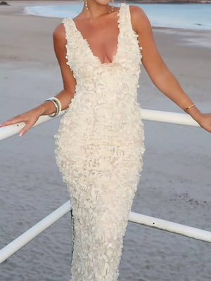 Elegant ivory floral applique maxi dress with deep V-neck and sleeveless design.