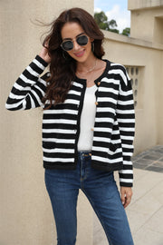 Black/White A striped crewneck cardigan with button front and pockets.