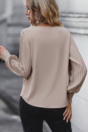 Mocha blouse with pleated long sleeves and cuffed wrists.