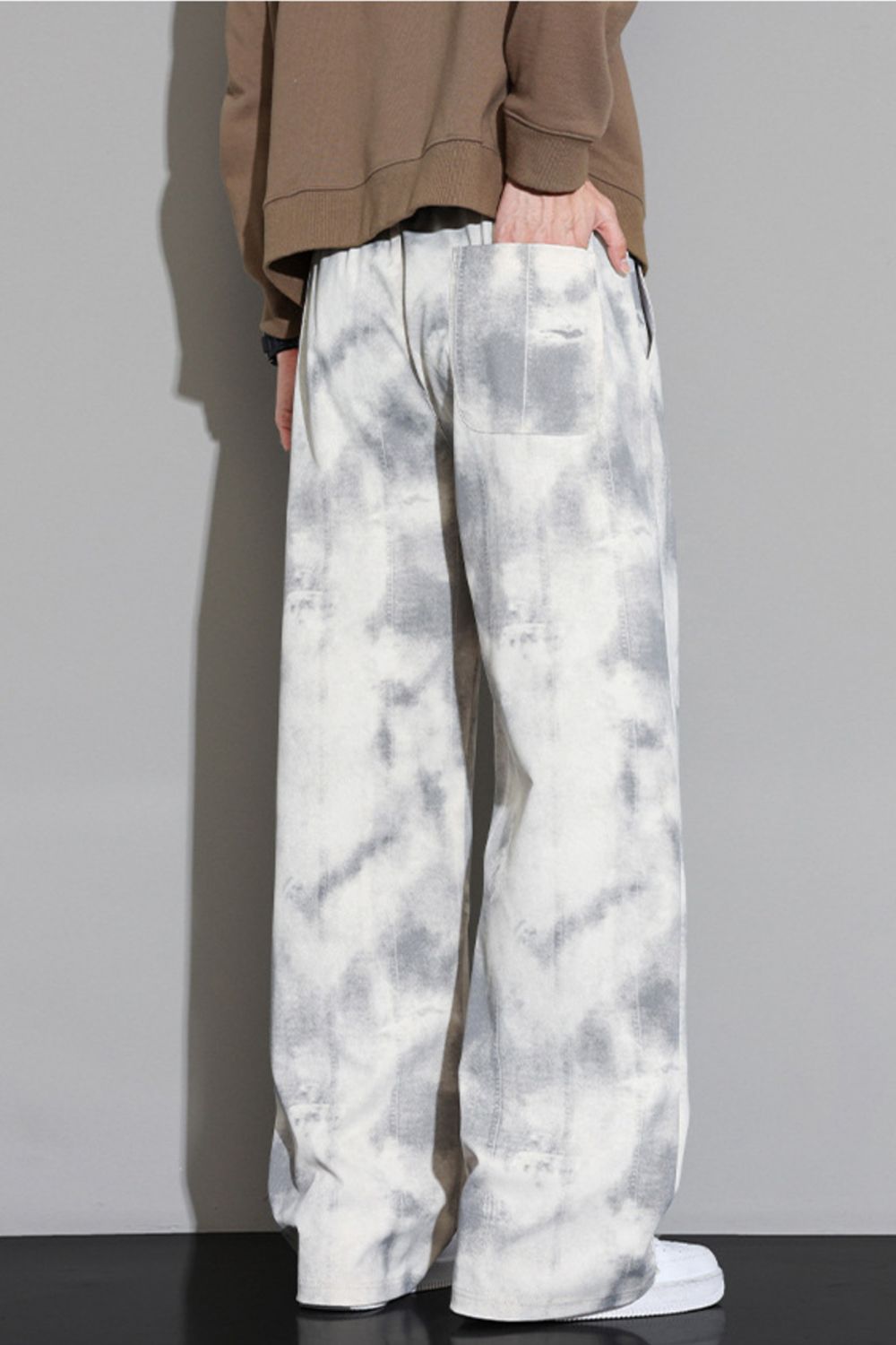 Relaxed fit sweatpants in off-white with a grey cloud pattern and elastic waistband.