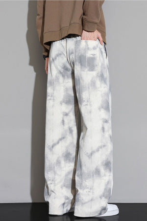 Relaxed fit sweatpants in off-white with a grey cloud pattern and elastic waistband.