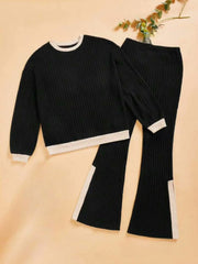 Black ribbed knit lounge set with contrast trim and slit hem pants.