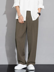 Men's brown wide-leg chinos with a relaxed fit, styled with a white shirt.