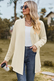 Cream textured open-front drape cardigan with long sleeves, styled with a white top and jeans.